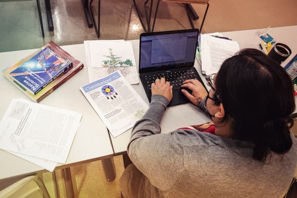 Study works on laptop in class