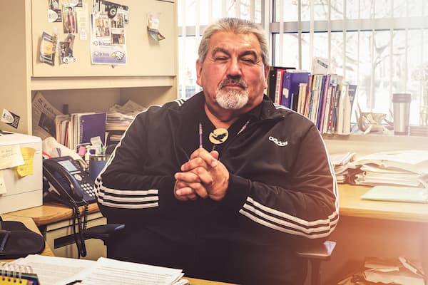 Artley Skenandore, Jr. poses for photo in his office at Oneida Nation High School