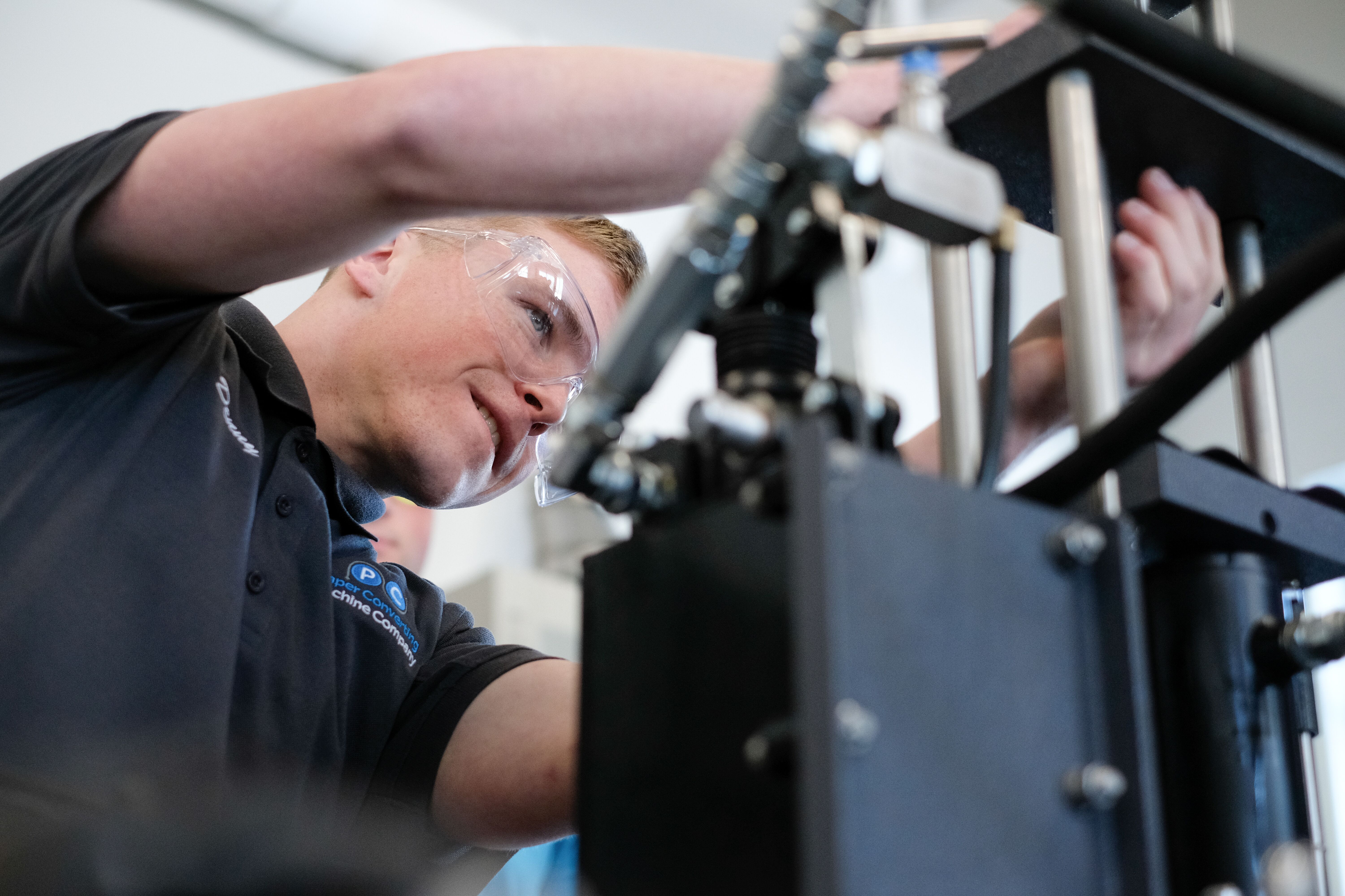 Engineering student working with machinery