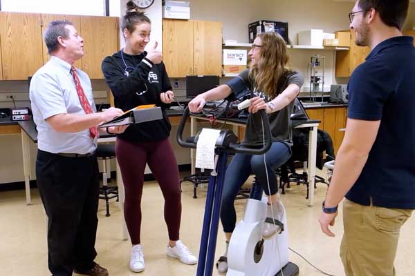 Students perform exercise science tests on peer