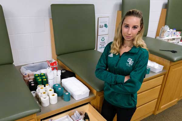 Althetic Training graduate student posing in athletic facility