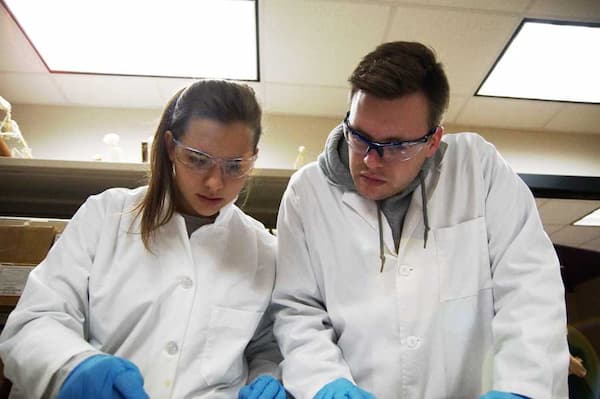 Two students working in lab