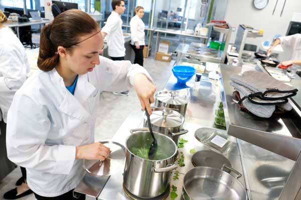 Student prepares food in STEM Center Kitchen