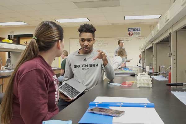 Two students work together in Human Biology Lab