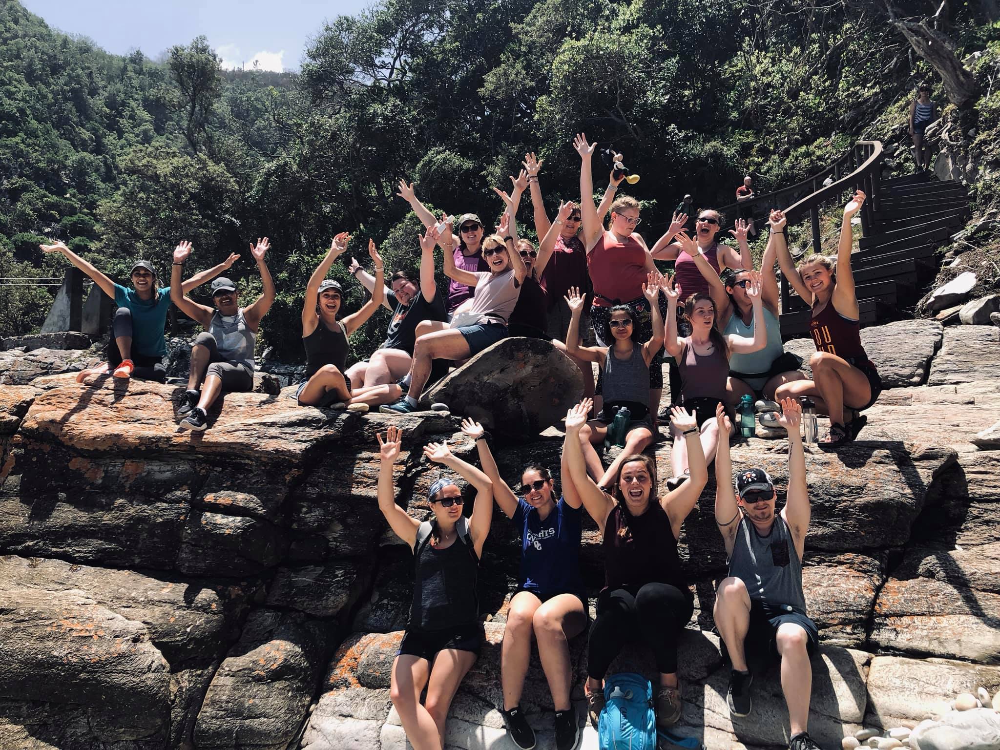 Group of students sitting on rocks