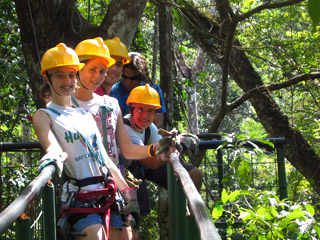 Students in hard hats on a suspended bridge