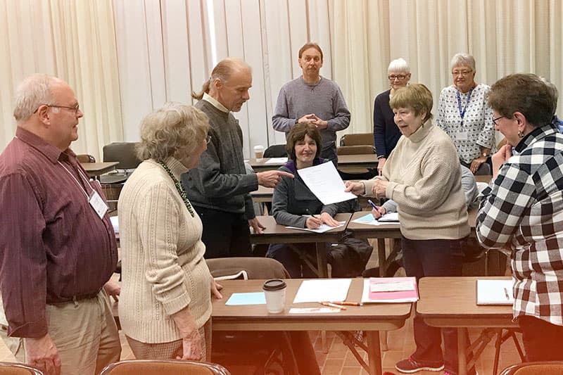 Members gathered in a classroom planning