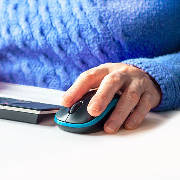 Mature womans hand on computer mouse
