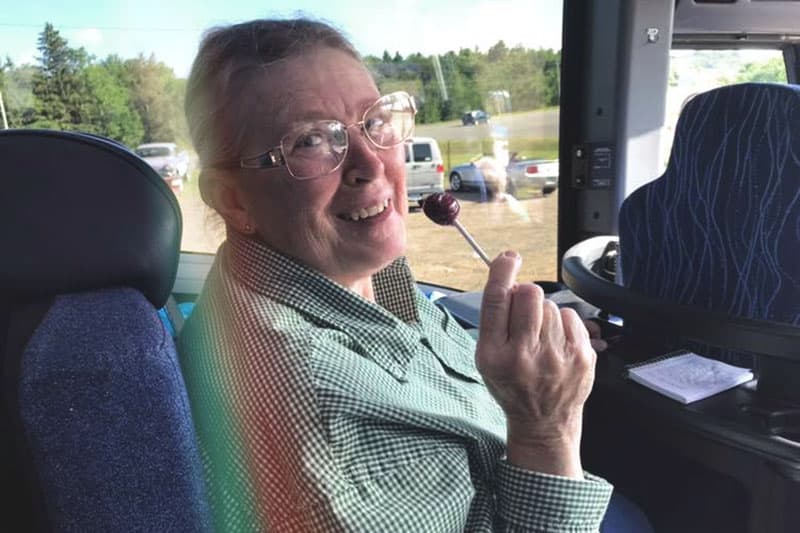 Member smiling on a bus trip