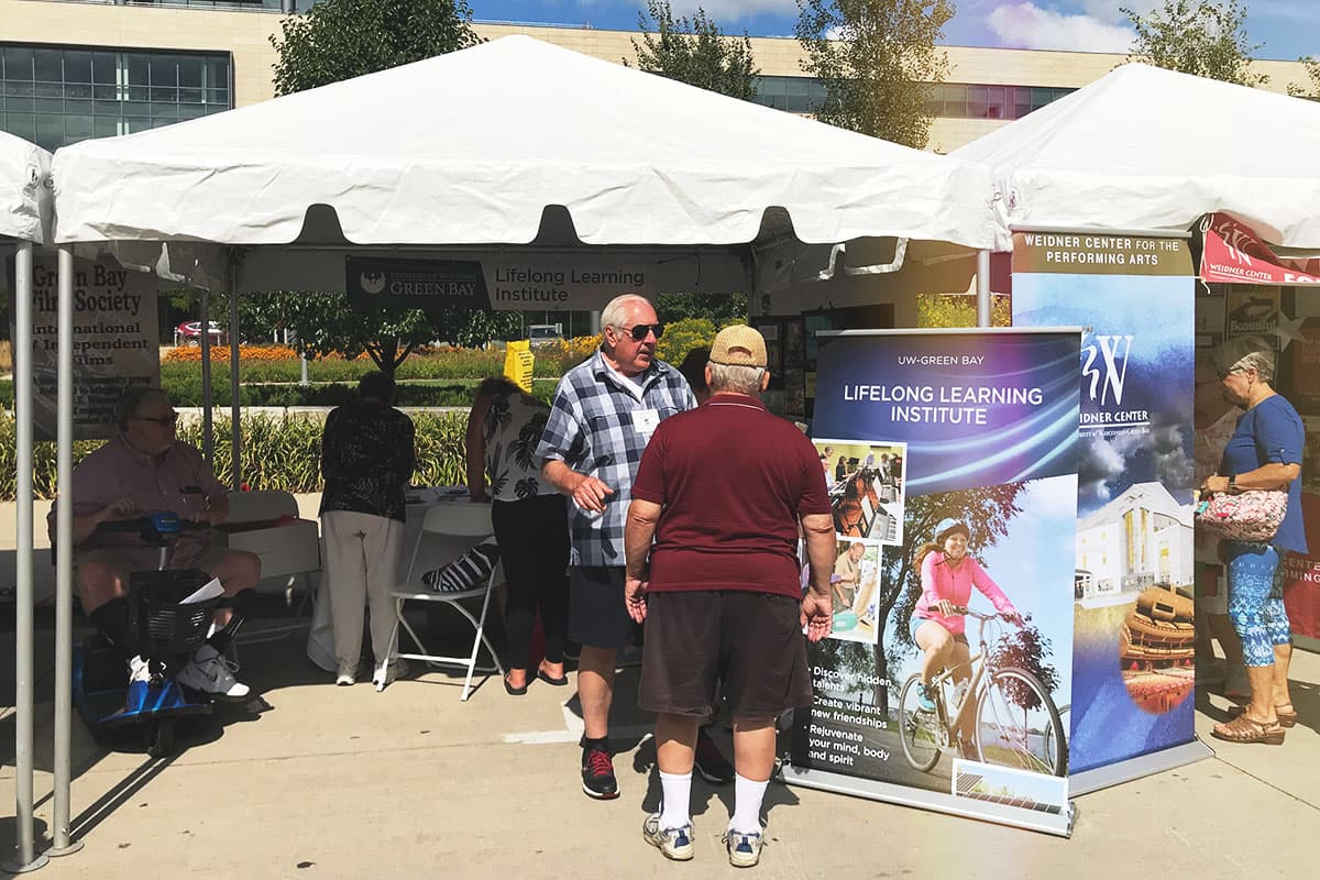 Members volunteering at Artstreet booth