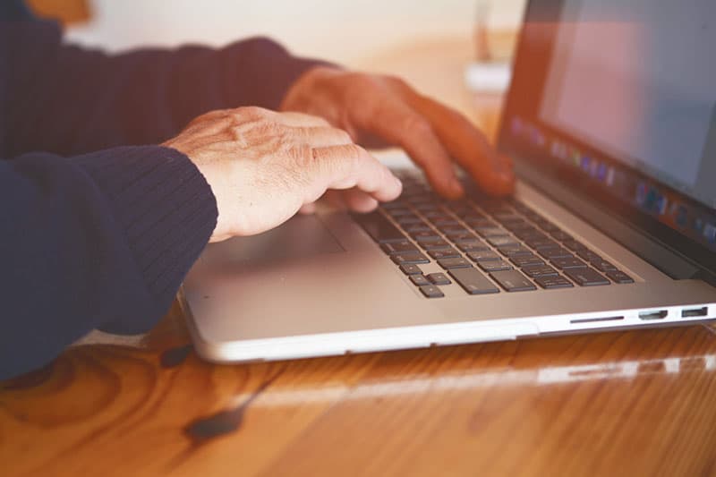 Persons hands typing on a keyboard