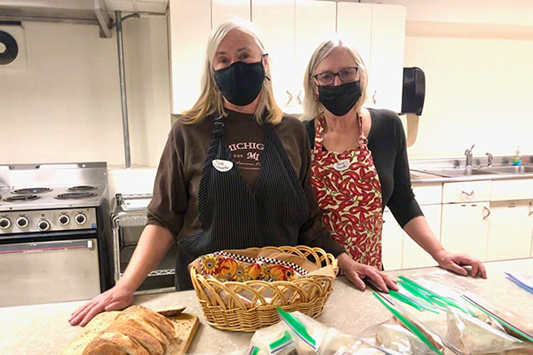 Two women having fun learning how to make bread