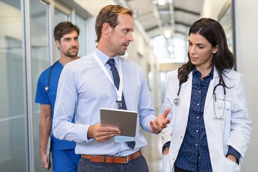 Nurse administrator talks with nurses in clinic