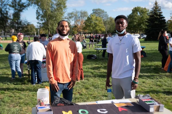 Two male students pose for photo at a student life event