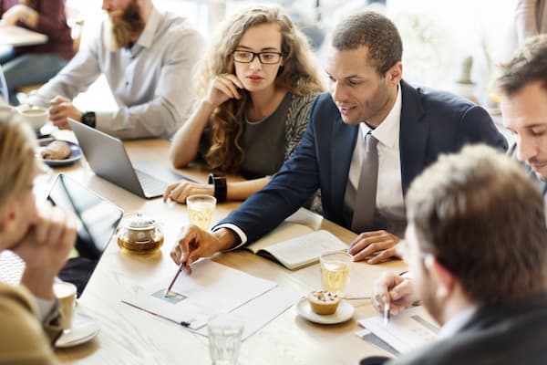 Coworkers go over paperwork at business meeting