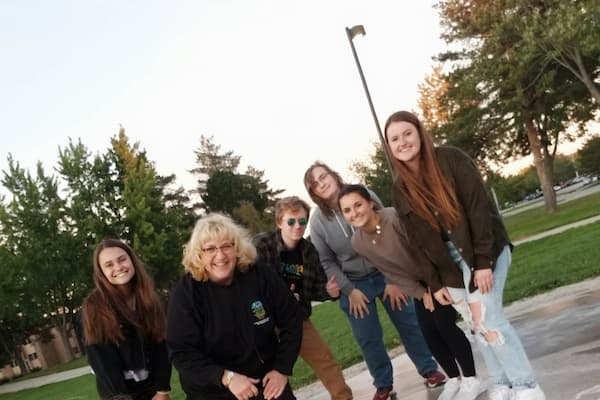 Students and professor pose for photo outdoors