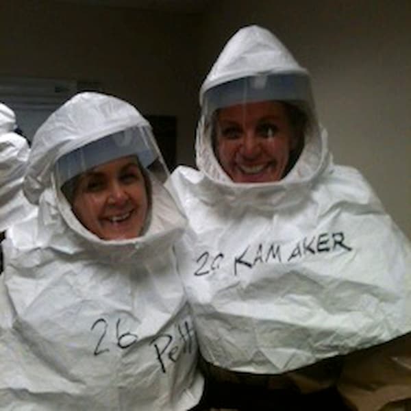 Martha Pettineo wearing a haz mat suit with a colleague