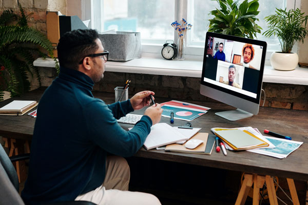 Male attending online marketing meeting