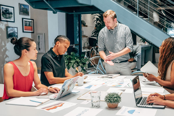 Group of people attend marketing meeting