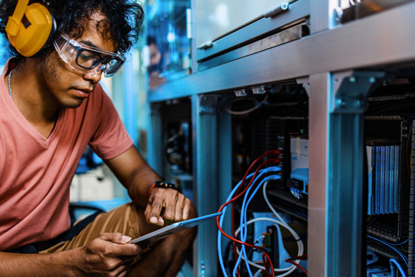 Male working on electrical circuits