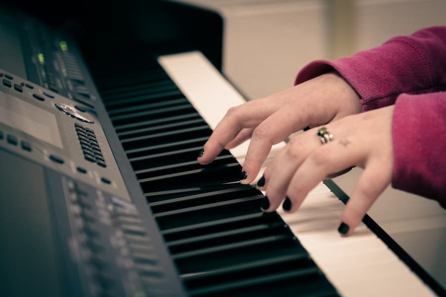 Close up of students hands playing on keyboard