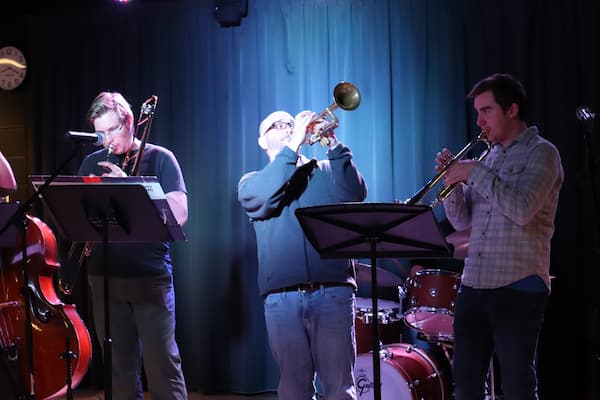 Students play in a jazz band on stage