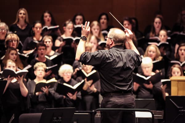 Professor orchestrating vocal ensemble