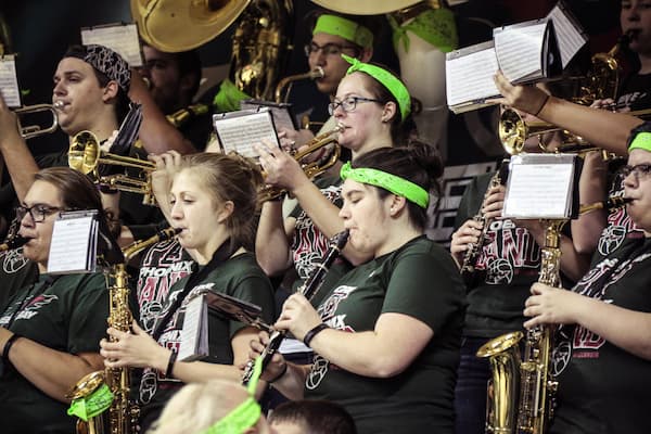 Students play in pep band at sporting event