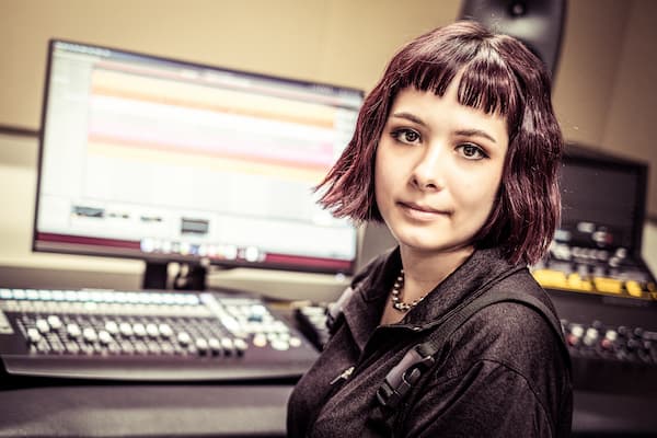 Student poses in music lab