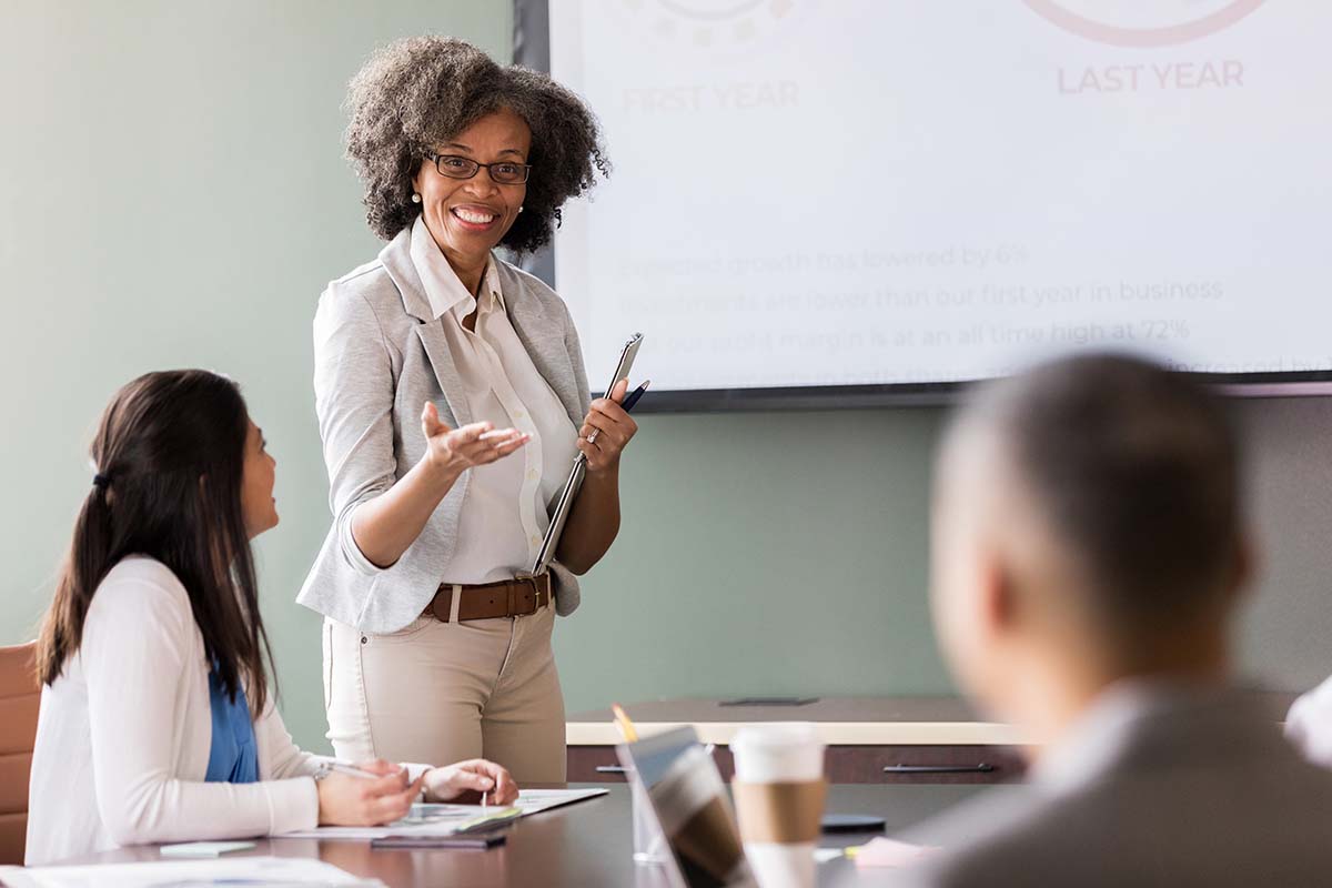 woman presenting at a nonprofit organization board meeting