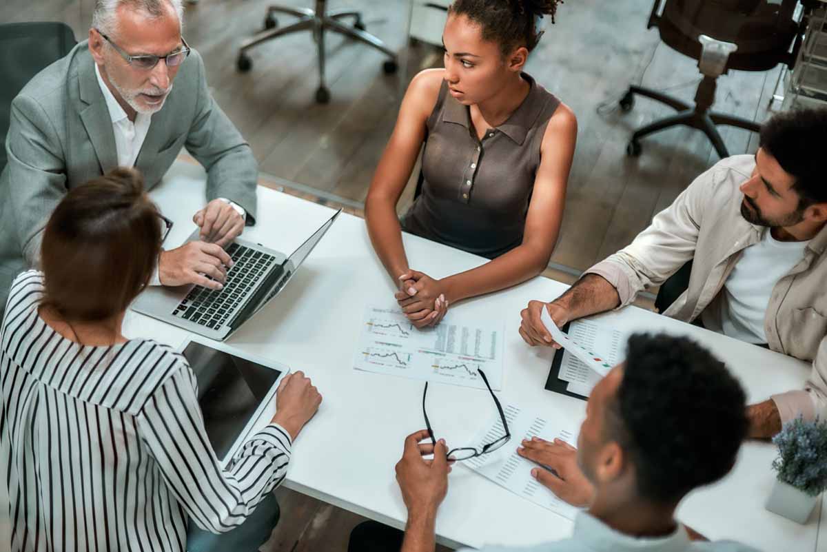 group of coworkers meeting at conference room table