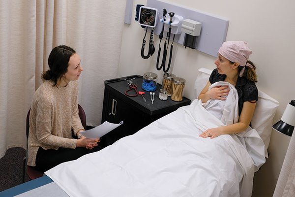 Nutrition and dietetics student working with patient in simulation lab