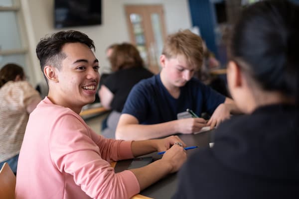 Students gather around table