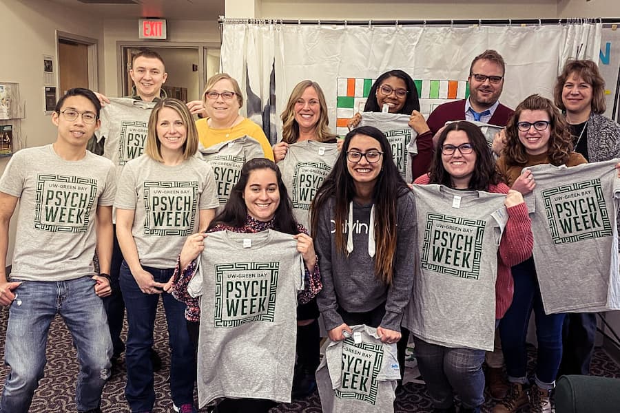 Students and faculty pose with psych week t-shirts