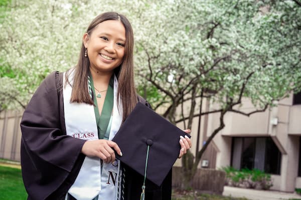 Female student poses with diploma