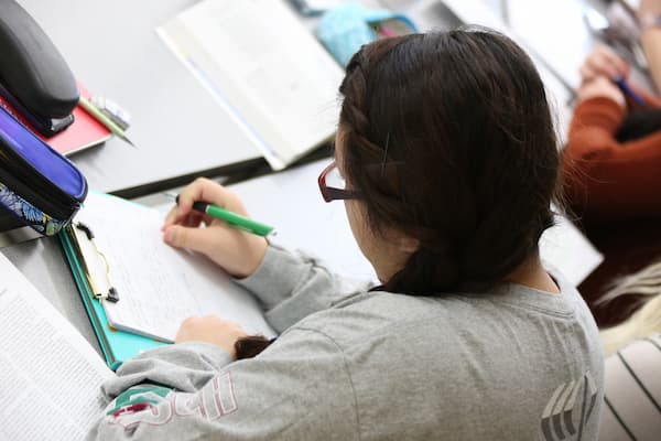 Female student studies at desk