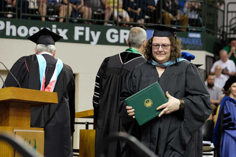 Student recieves diploma and commencement