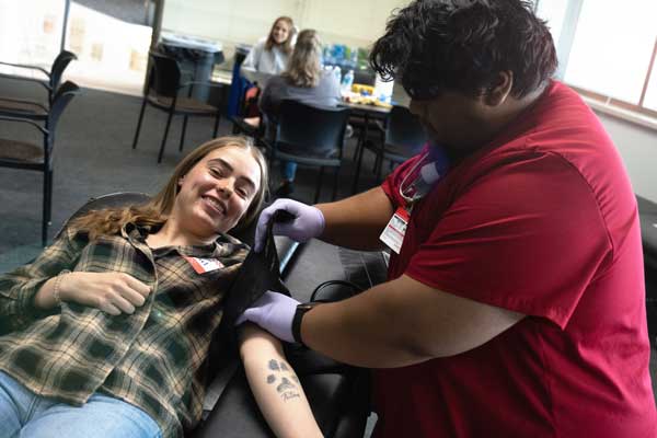 UWGB RN to BSN student takes womans blood pressure