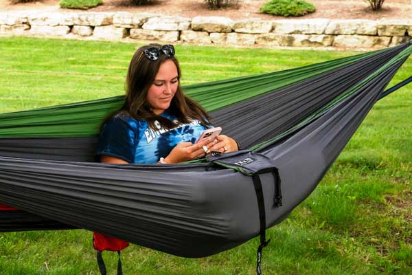 Student relaxes in hammock
