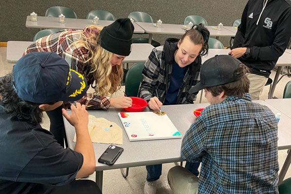 Group of students at a table doing crafts