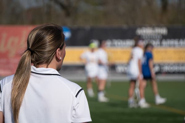 Sports Exercise and Performance Psychologist works with team during game