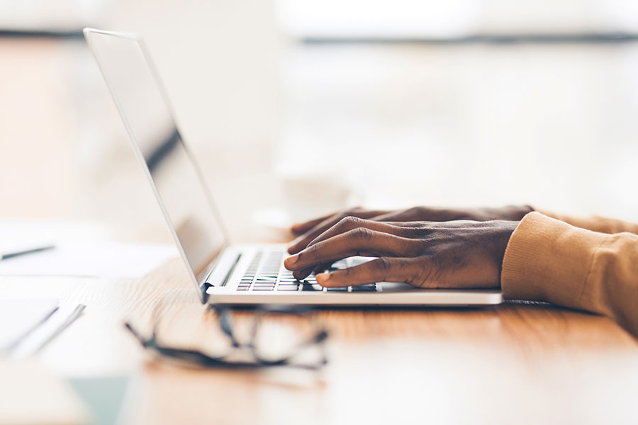 person of color using a laptop