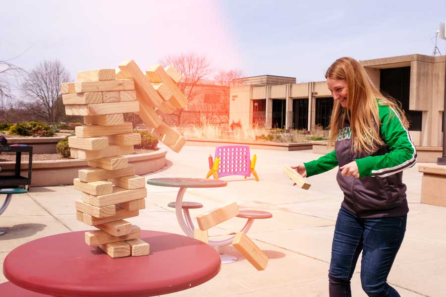 Student plays giant janga