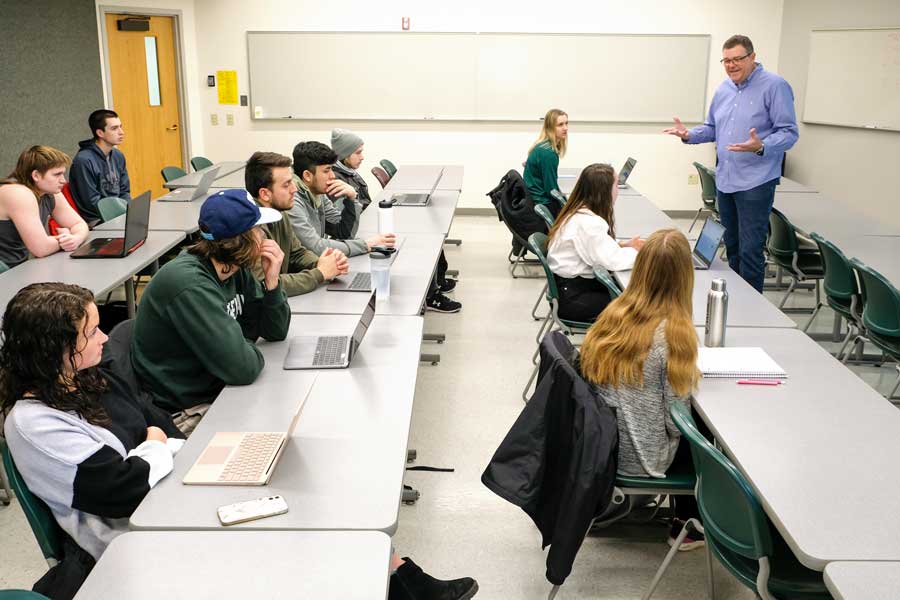 Professor gives lecture to students on supply management
