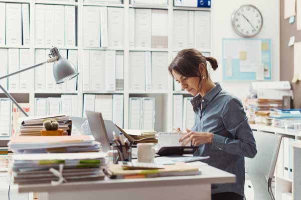 Female employee sorts out business paperwork