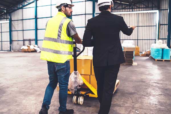 Employee and boss work with supply in shipping yard