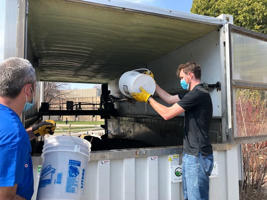 Dumping food waste into the UW-Green Bay composter