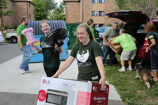 Student carying a microwave at freshman move-in day