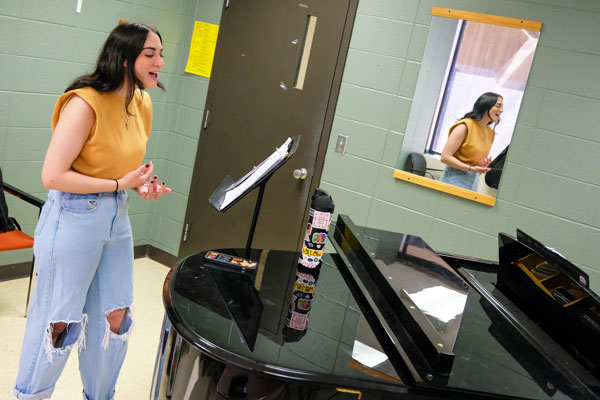 Student sings while professor plays piano