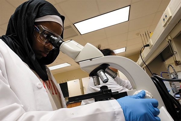 A student using a microscope.